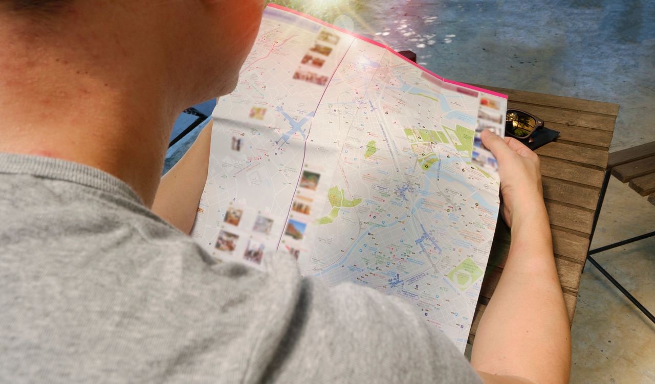 about-me Traveler studying a map for directions, symbolizing exploration and adventure.